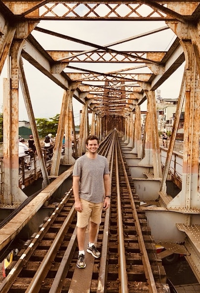 Robert walking across Long Biên Bridge in Hanoi, Vietnam.